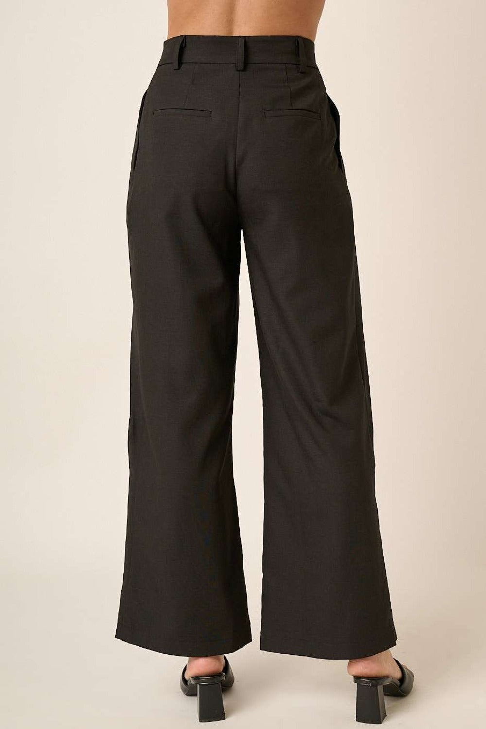 Back close-up of Mittoshop deep pleated high waisted wide leg pants, showcasing tailored fit and back pocket details.