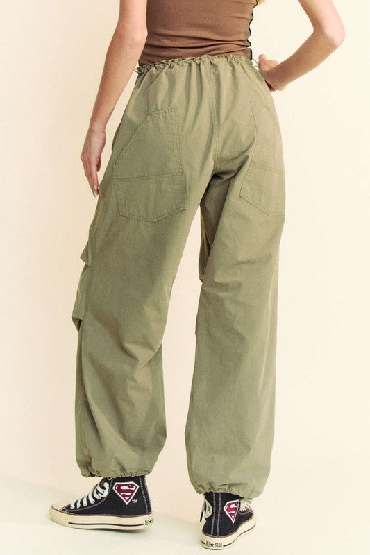 Back view of Davi & Dani drawstring baggy pants with pockets in olive green, showcasing rear pocket details and elastic waistband.