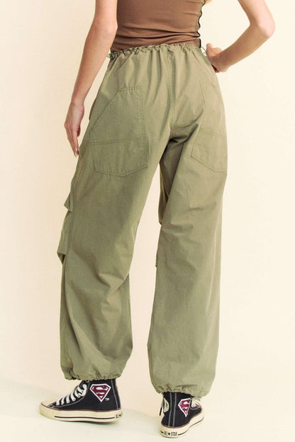 Back view of Davi & Dani drawstring baggy pants with pockets in olive green, showcasing rear pocket details and elastic waistband.