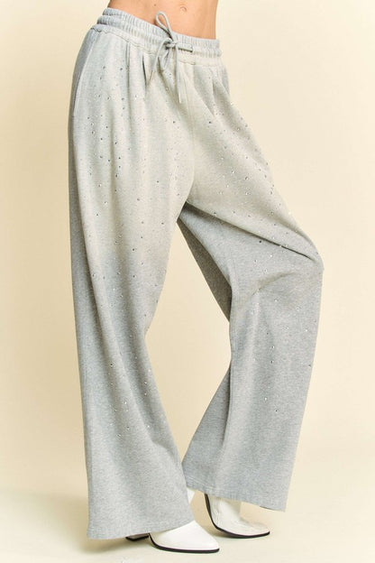 Side angle of Davi & Dani Rhinestone Drawstring Wide Leg Pants in light gray, highlighting rhinestone embellishments and wide-leg design.