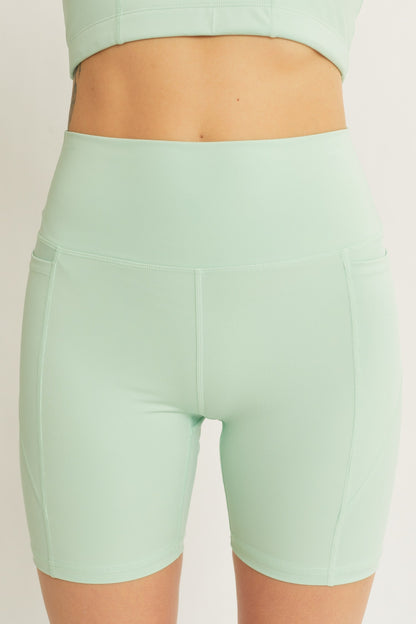 Front view of Love Tree High Waist Seam Detail Active Shorts in mint green, featuring a seamless high-waist fit and smooth stitching.