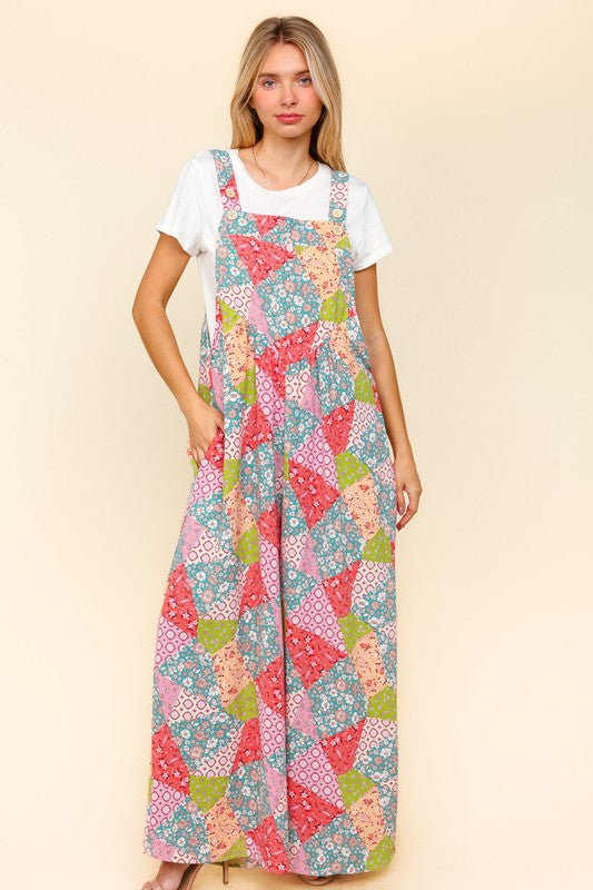 Front view of Haptics full-size printed wide-leg overalls showcasing a colorful patchwork design and side pockets.