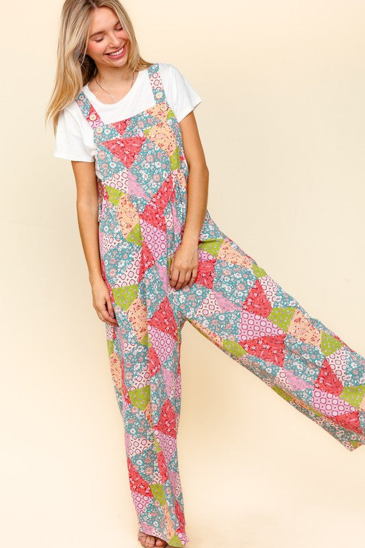 Haptics full-size printed wide-leg overalls with colorful patchwork design and side pockets, styled with a white t-shirt.