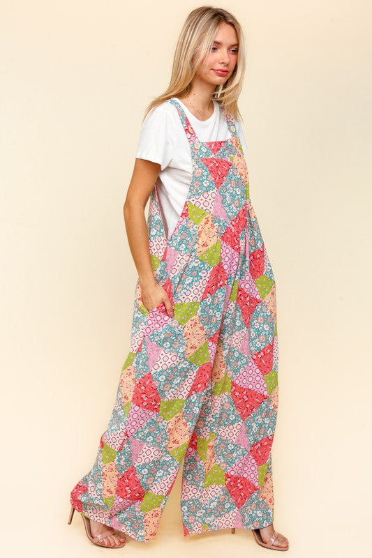 Side view of Haptics full-size printed wide-leg overalls with a colorful patchwork pattern and functional side pockets.