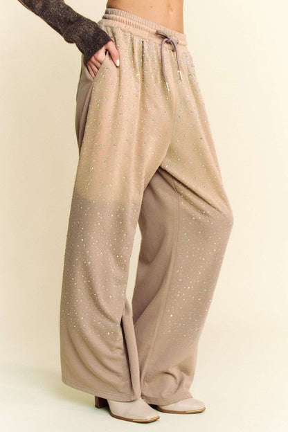 Side view of Davi & Dani rhinestone drawstring wide-leg pants in beige, highlighting the sparkling rhinestones and wide-leg design.