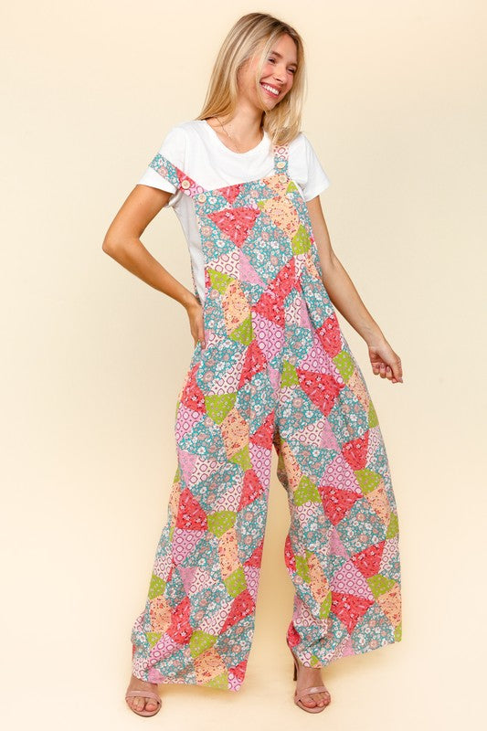 Haptics full-size printed wide-leg overalls in a vibrant patchwork design, styled casually with a white t-shirt and side pockets.