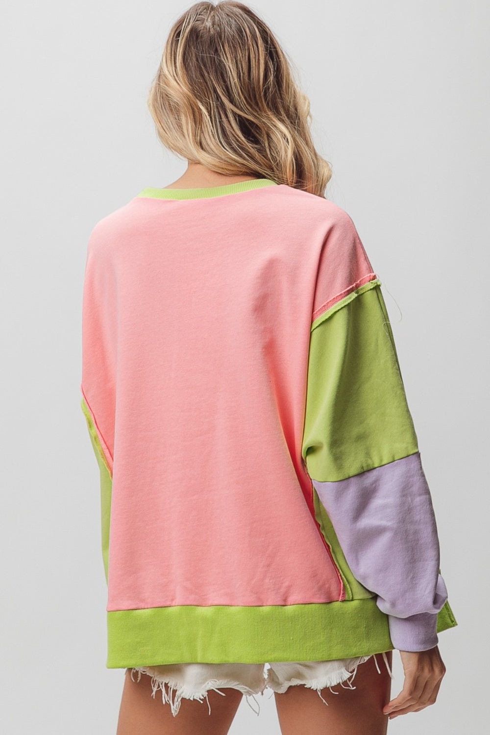 Back view of BiBi Washed Color Block Sweatshirt showcasing pink, green, and lavender color block design with a loose, casual fit.